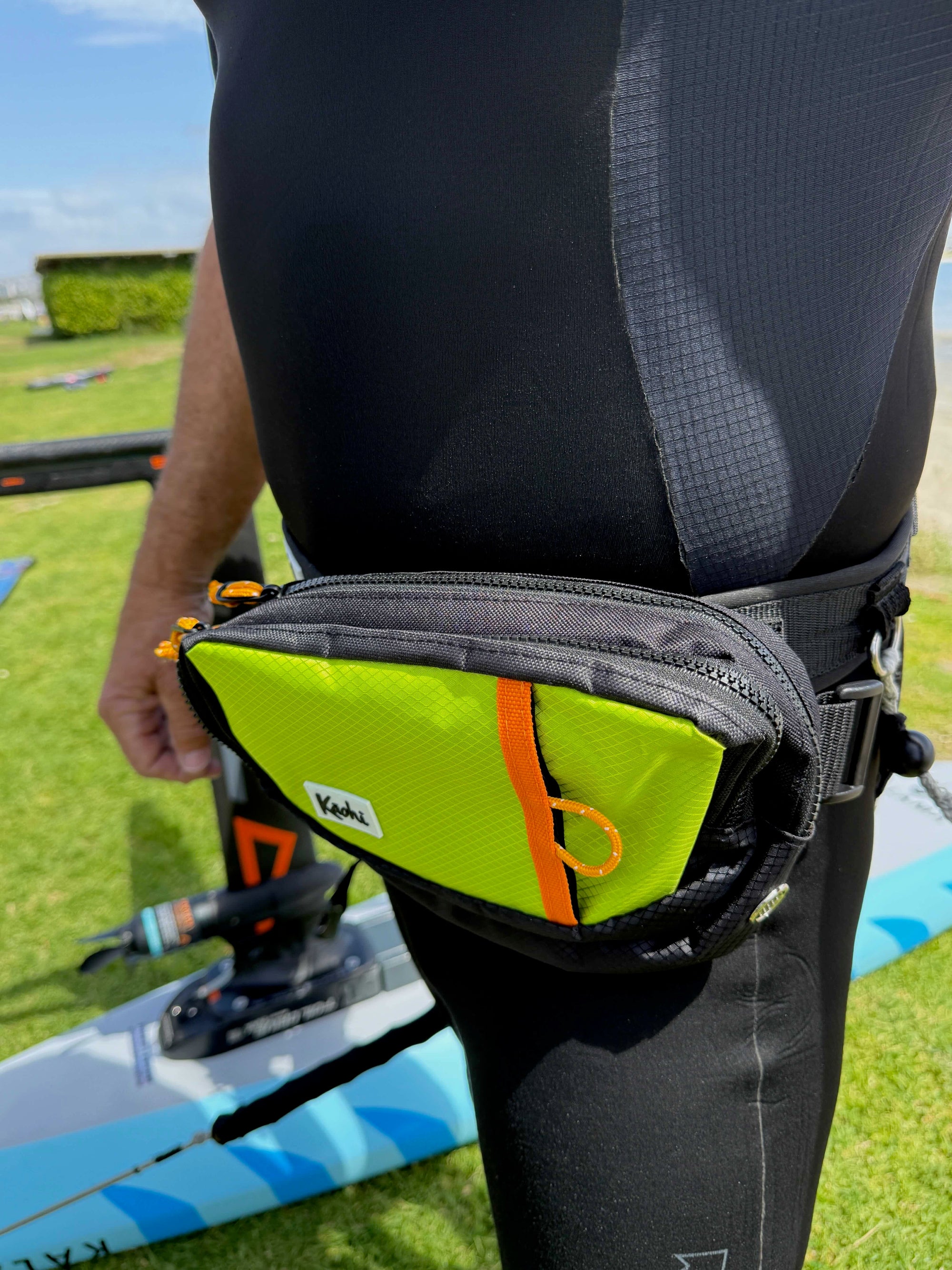 Downwind foiling pouch waist bag safety butt bag pack K-Pack Kaohi SUP foil hydrofoil foil assist down winding leash harness High viz travel bag Hawaiian Watersports